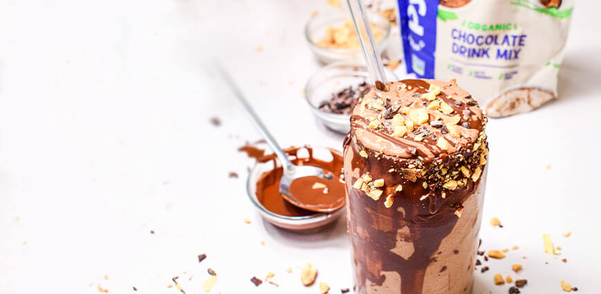 Low-Sugar Coffee, peanut butter, and Chocolate Protein Smoothie in glass with spoon