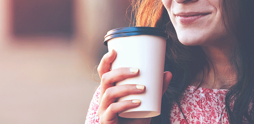 woman holding coffee cup.  Learn a woman’s healthy solution to drinking black coffee