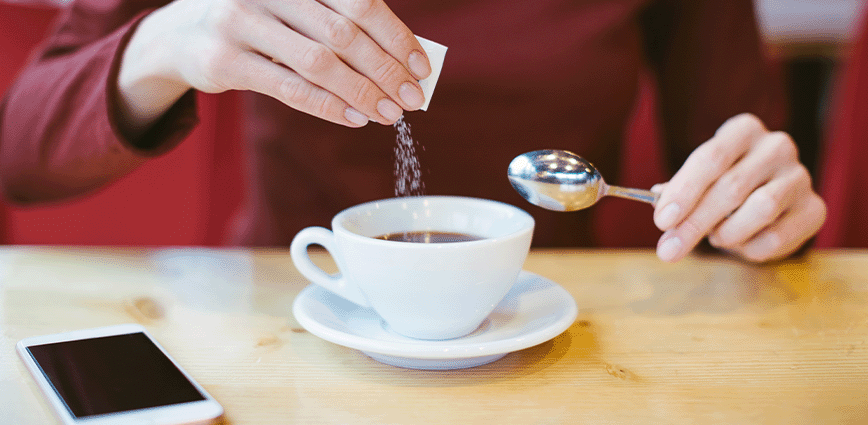 man using monk fruit sugar packet for a zero glycemic index coffee