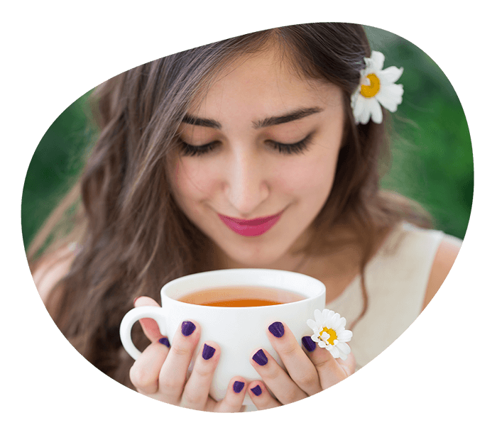 Woman holding tea cup. Pyure Organic Sweeteners and liquid stevia are great for sweetening coffee and tea. 
