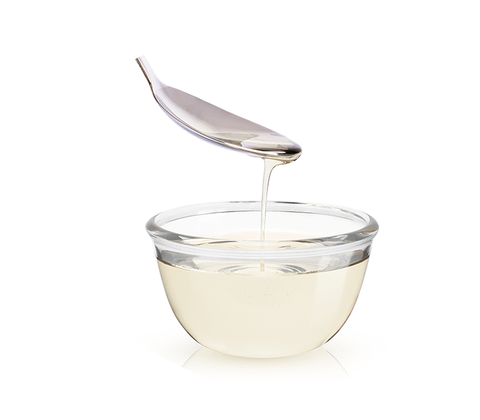 Allulose sweetener syrup in a glass jar with spoon. 
