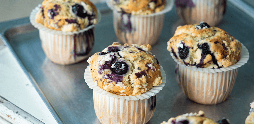 High Protein Low Sugar Blueberry Streusel Muffins on a Sheet Pan