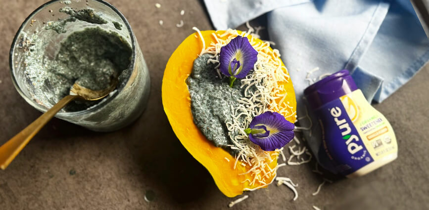 Blue Butterfly Chia Pudding in Papaya in Cup with Bottle of Pyure Liquid Stevia