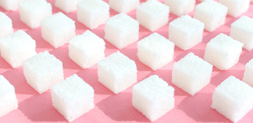 White sugar cubes graphic for "downsides of refined sugar" article