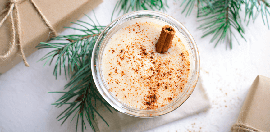 Spiked Eggnog with cinnamon stick as an example of Lower Sugar Holiday Cocktail