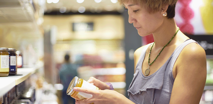 lady reading nutritional label trying to Kick Sugar Cravings