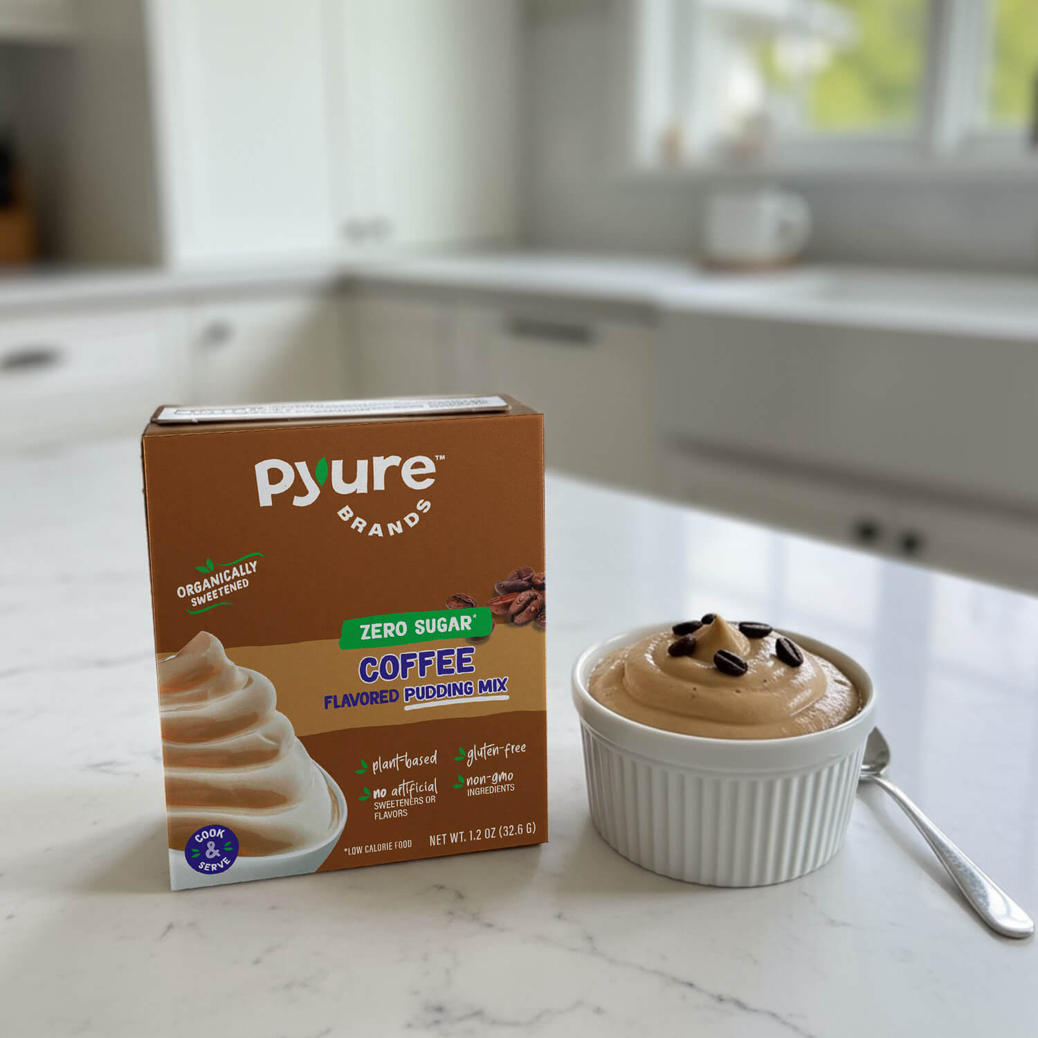 Pyure Brands coffee-flavored pudding mix box on a kitchen counter with a bowl of pudding. Plant-based, organically sweetened sugar-free pudding snack; vegan & dairy-free, gluten-free instant dessert, low/no calorie coffee flavor dessert 