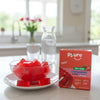 Pyure strawberry-flavored jelly cubes on a table with package. Zero sugar, plant based light dessert.