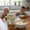 Two happy children eating a bowl of Pyure Vanilla Pudding with Zero Sugar